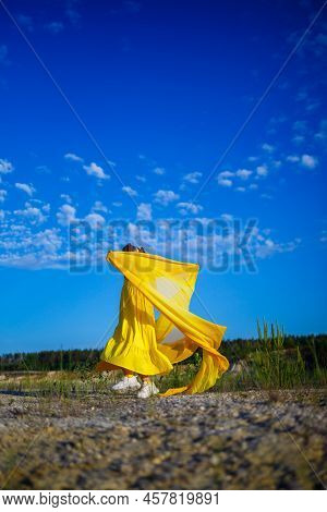 The Symbol Of Freedom Is A Ukrainian Girl Of 7 Years Old, Patriotically Dressed In A Yellow Dress Ag