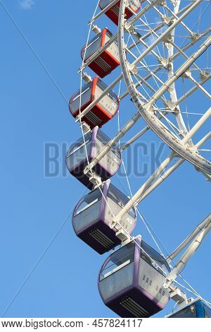 Closeup Of Multicolored Tempozan Ferris Wheel In Amusement Park With Blue Sky In Tbilisi, Georgia. B