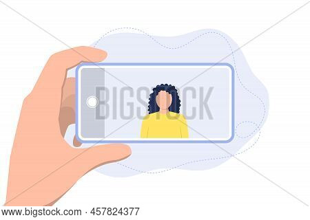 Man Holds A Phone In His Hands And Takes A Picture Of A Girl.