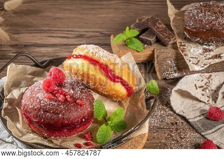Bolas De Berlim, Or Berlin Balls. Portuguese Fried Dough With Sugar, Filled With Chocolate Or Raspbe