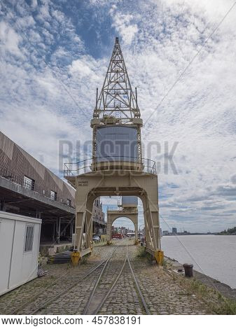 Antwerp, Belgium, July 02, 2022, Old Crane On The Quay Next To The River Scheldt On Train Rails Next