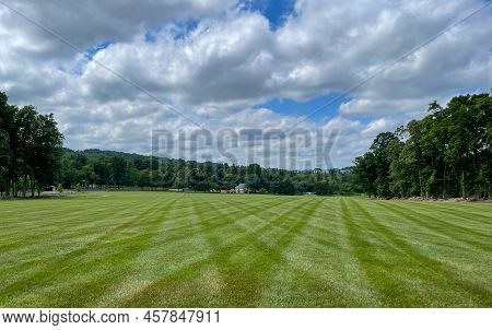 A Newly Mown Lawn With Beautiful Lush Green Stripes.