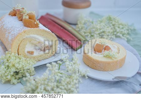 Sweet Home Made Bisuit Roll With Rhubarb And Elderflower On A Table