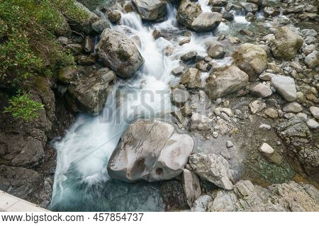 Small Waterfall Tumbling And Splashing Down In Bealey River In Southern Alps