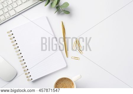 Business Concept. Top View Photo Of Workstation White Keyboard Computer Mouse Open Notebook Cup Of C