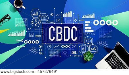 Cbdc - Central Bank Digital Currency Concept With A Laptop Computer On A Blue And Green Pattern Back