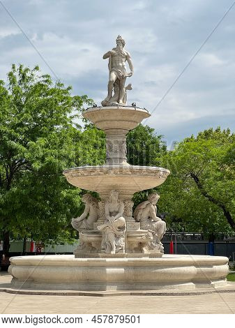 Danubius Fountain Among Green Trees In Elisabeth Square. Budapest, Hungary