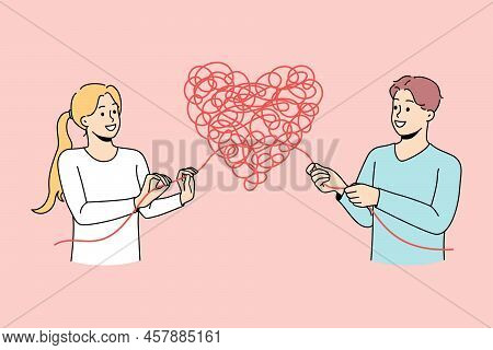 Man And Woman Untangle Heart Solve Relationship Problem. Couple Find Solution To Relation Trouble. D