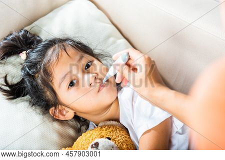 Sick Kid. Mother Parent Checking Temperature Of Her Sick Daughter With Digital Thermometer In Mouth,