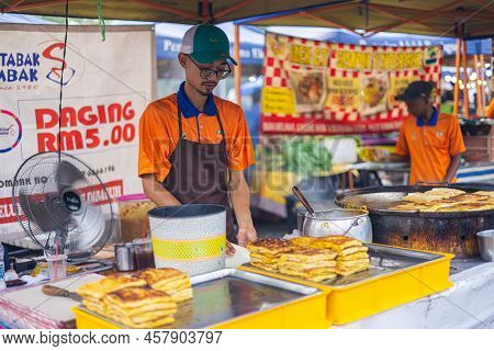 Kuala Lumpur, Malaysia - June 21, 2022: Young Man At A Fresh Market In Kl, Is Cooking Homemade Murta