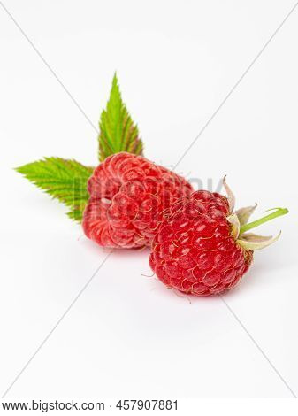 Ripe Raspberries With Leaf Isolated On A White Background
