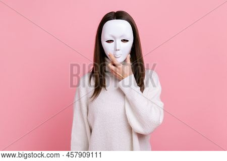 Brunette Woman Covers Face With White Mask, Hiding Personality, Anonymous Identity, Being Dishonest,