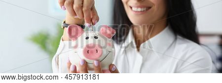 Portrait Of Happy Woman Putting Coins In Piggybank Container And Smiling. Save Money, Collect Cash, 