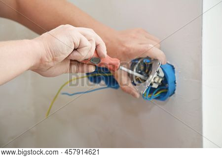 Electrican Installing Socket, Outlet Plug In New House Wall.