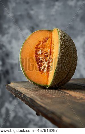 Cut Melon On A Wooden Table. Grey Background. Best Fruit In Summer. Fruit. Healthy Food Concept. Fro