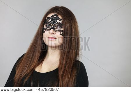 Pretty Mysterious Woman Wearing Black Eye Lace Mask Having Long Brown Hair.