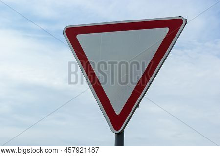 Road Sign Against The Sky. White Triangle With Red Border. Signal, Give Way. Summer Day