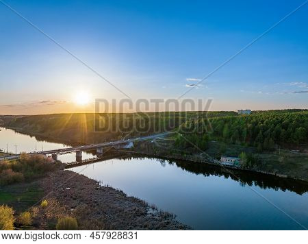Beautiful View Of The Bridge Across The Iset River In The City Of Kamensk-uralsky At Sunset In Sprin