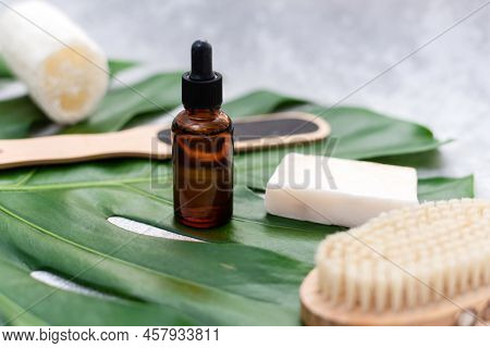 Natural Cosmetics For Bathing On The Background Of A Palm Leaf. Body Moisturizing Soap, Serum And Oi