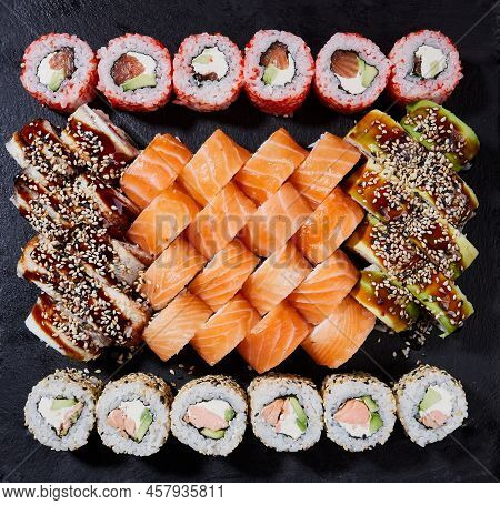 Asian Food Fest. Close Up Various Kinds Of Sushi Served On A Dark Background.