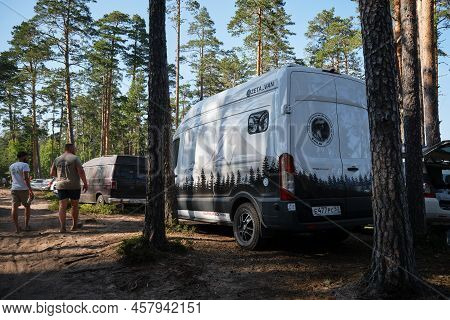 Leningrad Region, Russia - June 2022. Stylish Bus For Traveling. Camper In A Coniferous Forest. Home