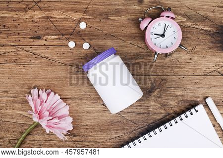 Women Health, Middle Age And Menopause Concept. Health Care Style. Copy Space. White Plastic Bottle 