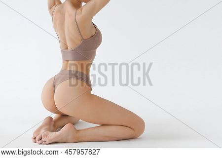 Fitness Model With Beautiful Buttocks Behind View. Legs And Booty Of Young Slim Girl In Sexy Sports 