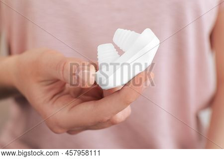 Woman Holding Anti-snoring Device For Nose, Closeup