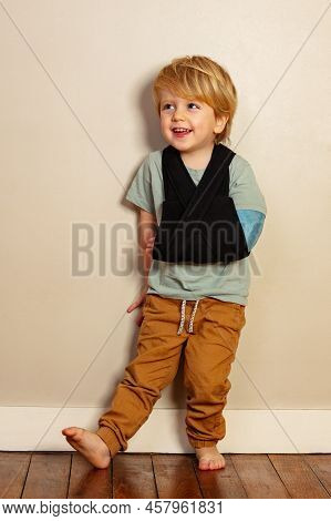 Laughing Young Boy With Broken Hand In Cast After Accident