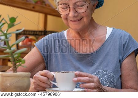 Close Up Portrait Of Attractive Senior Woman Blue Dessed Sitting At The Cafeteria Table Having Break