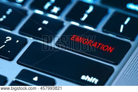 Emigration Concept With Text Emigration On Return Key Of Laptop Keypad.