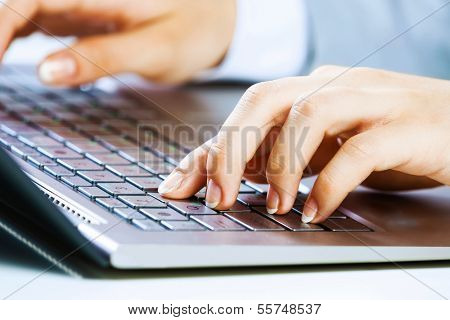 Close up image of businesswoman hands typing on keyboard