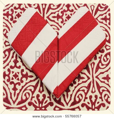 an origami heart on a patterned background with a retro effect