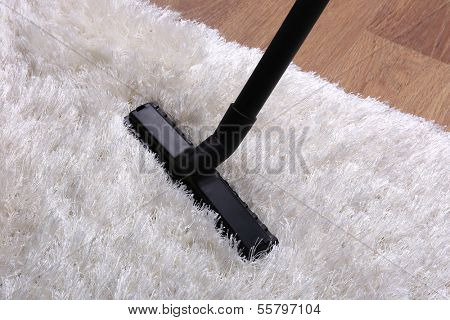 Vacuuming carpet in house