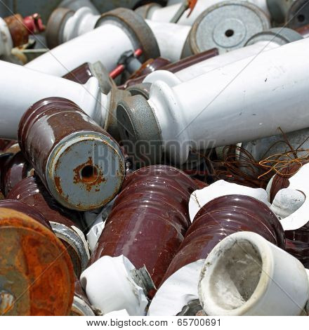 Many Pieces Of Iron And Ceramic Electrical Insulators In An Industrial Waste Landfill