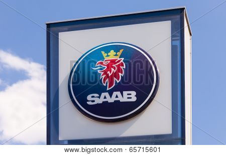 Samara, Russia - May 24, 2014: The Emblem Saab Over Blue Sky. Saab Automobile Ab Is A Swedish Premiu