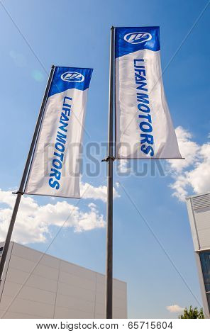 Samara, Russia - May 25, 2014: The Flags Of Lifan Motors Over Blue Sky. Lifan Group Is A Privately O