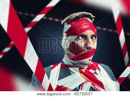 Man with stripped duct tape over body