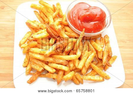 Spicy Fries Served On A White Plate With Catsup