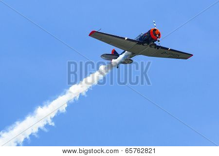 BERLIN, GERMANY - MAY 20, 2014: The aircraft Red Bull Noorduyn AT-16 D-FHGK demonstration during the International Aerospace Exhibition ILA Berlin Air Show-2014.