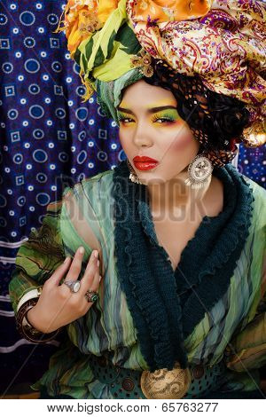 beauty bright woman with creative make up, many shawls on head like cubian woman
