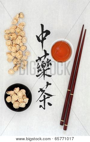 Chinese herbal tea calligraphy script on rice paper with astragalus herb, teacup and chopsticks. Translation of script reads as chinese herbal tea.