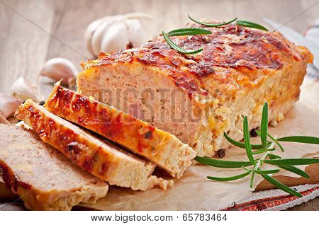 Homemade ground meatloaf with ketchup and rosemary