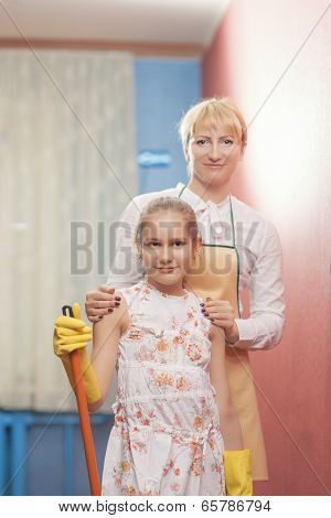 Mother And Daughter Doing Tidy Up Together