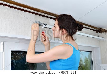 Girl Hangs Vertical Blinds, Tighten With A Screwdriver, Screw Brackets