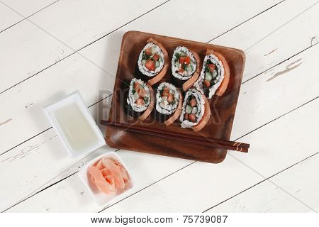 fresh sushi sashimi nigiri with raw salmon slice red ginger and japanese vinegar on wooden plate over white table high resolution hidef