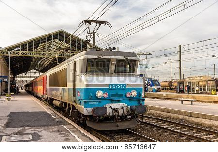Narbonne, France - January 06: Passenger Train Hauled By Electric Locomotive At Narbonne Station On