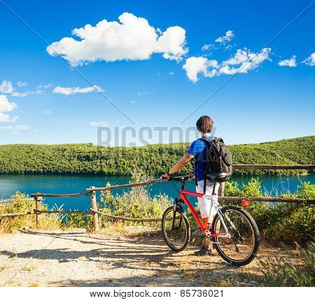 Man with a Bike on Beautiful Nature Background