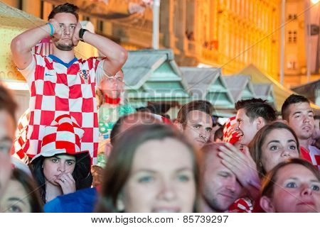 ZAGREB, CROATIA - JUNE 12, 2014: Croatian football fans at Ban Josip Jelacic square support their national team during the world cup match between Croatia and Brazil.