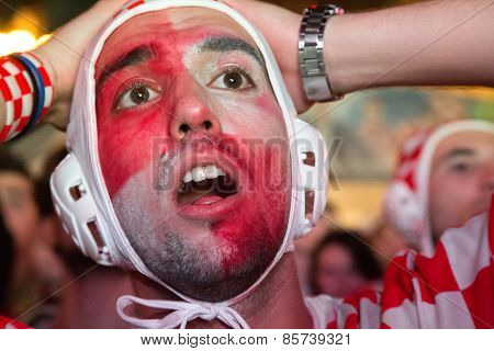 ZAGREB, CROATIA - JUNE 12, 2014: Croatian football fan wearing water polo cap at Ban Josip Jelacic square support national team during the world cup match between Croatia and Brazil.